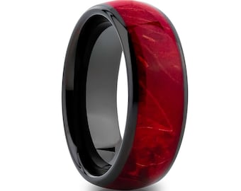 May include: A black ceramic ring with a red wood inlay. The ring has a polished finish and a beveled edge.