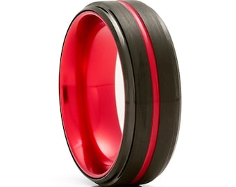 May include: A black tungsten carbide ring with a red inner band and a red line around the outer edge.