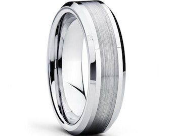May include: A silver tungsten carbide ring with a beveled edge and a brushed finish.