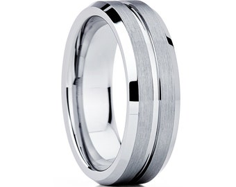 May include: A silver tungsten carbide ring with a beveled edge and a brushed finish. The ring has a single, polished groove running around the center.