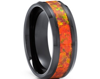 May include: A black tungsten carbide ring with a band of orange and green opal inlay.