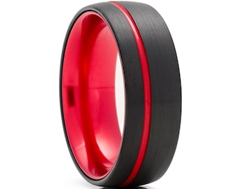 May include: A black tungsten carbide ring with a red inner band and a red line around the outer edge.