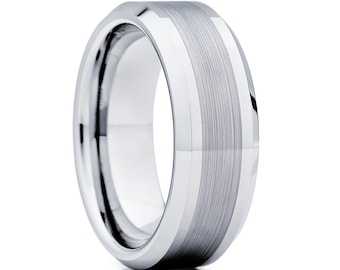 May include: A polished silver ring with a brushed metal center band. The ring has a beveled edge and a smooth, reflective surface. The design is modern and minimalist, suitable for everyday wear or special occasions.