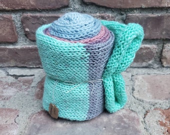 Homemade knit tube scarf with green, blue, and purple tones