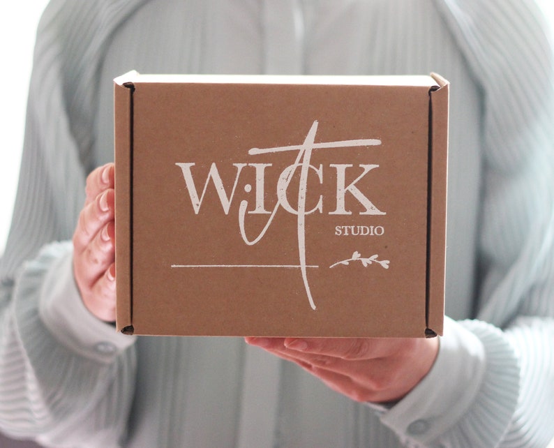 May include: A brown cardboard box with the text "WICK STUDIO" printed in white on the front.