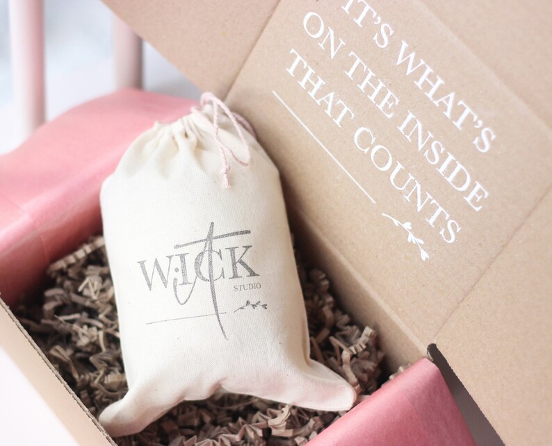 May include: A white canvas bag with a black logo that says "WICK STUDIO" inside a brown cardboard box with the text "IT'S WHAT'S ON THE INSIDE THAT COUNTS".