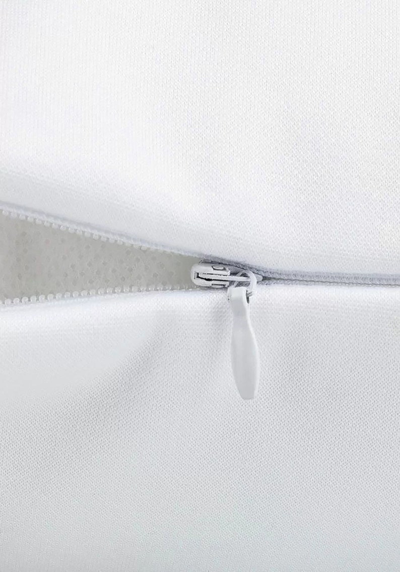 May include: A white pillow cover with a zipper closure. The zipper is open and the white fabric lining is visible.