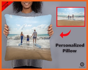 May include: A personalized pillow with a photo of a family of three walking on a beach. The photo shows a woman, a man, and a child holding hands and walking towards the ocean. The sky is blue and the water is turquoise. The sand is white and the waves are crashing on the shore.
