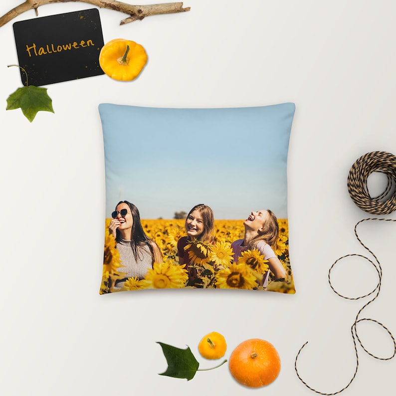 May include: Three women laughing in a field of sunflowers. The women are wearing casual clothing and sunglasses. The sky is blue and the sunflowers are in full bloom.