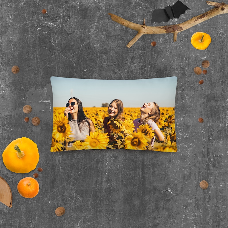 May include: Three women laughing in a field of sunflowers. They are wearing casual clothing and sunglasses. The sunflowers are in full bloom and the sky is blue.