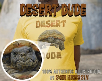 May include: A yellow t-shirt with a brown tortoise illustration and the text "DESERT DUDE" in brown letters. The text "DESERT" is above the tortoise and the text "DUDE" is below the tortoise. The text "100% AUTHENTIC ILLUSTRATION BY SAM KRESSIN" is at the bottom of the shirt.
