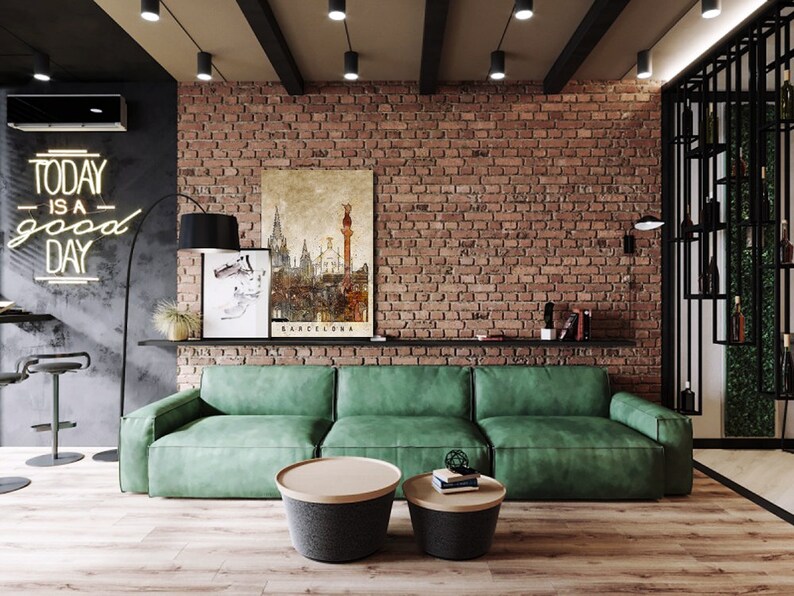 May include: A green sofa with two round coffee tables in front of it. The sofa is in a living room with a brick wall and a neon sign that says "Today is a good day".