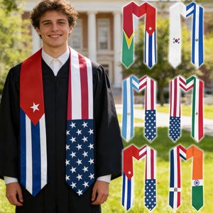 May include: A person in a black graduation gown with a selection of graduation stoles. The stoles display flags of Cuba, the United States, South Korea, Guyana, Argentina, and India. The stoles are in red, white, blue, and green, and are worn over a white shirt.