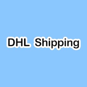 May include: White sticker with black text that reads "DHL Shipping".