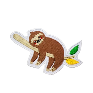 May include: Embroidered iron-on patch featuring a brown sloth with a smile hanging on a branch with green and yellow leaves.