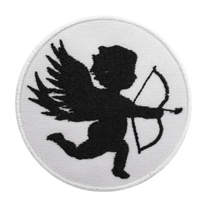 May include: A round, white patch with a black silhouette of Cupid, holding a bow and arrow, with large wings. The patch has a white stitched border. The Cupid is running.