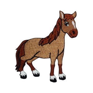 May include: Embroidered patch of a cartoon horse. The horse has a tan body, brown mane and tail, and white markings on its face and hooves. The patch is designed with a detailed, stitched texture, and a black outline.