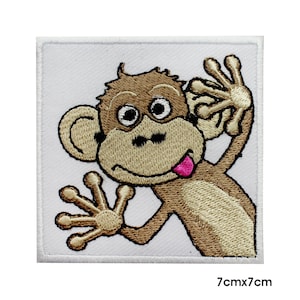 May include: Embroidered iron-on patch featuring a cartoon monkey with a brown body, white eyes, and a pink tongue sticking out. The monkey is waving with one hand and has its other hand behind its ear. The patch is 7 cm by 7 cm.