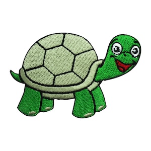 May include: Green and white embroidered patch of a smiling cartoon turtle with a shell.