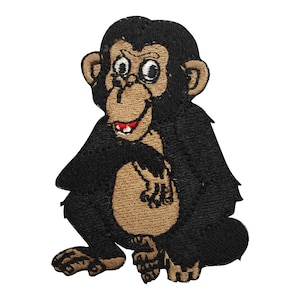 May include: A black and brown embroidered patch of a cartoon monkey with a big smile. The monkey is sitting with its arms crossed and has a brown face and hands.