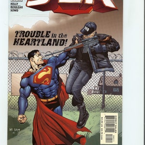 May include: Comic book cover for JLA #80, featuring Superman in a fight with a man in black tactical gear. The title "THE WHITE RAGE" is displayed prominently. The cover art is a vibrant illustration with action-packed imagery.