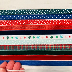 May include: Assortment of ribbon trims in various colors and patterns, including polka dots, stars, plaid, and velvet. The ribbons are arranged in rows on a white surface.
