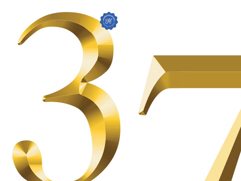 May include: A 3D gold-colored number 37. The number 3 is stylized with a curved design. The number 7 is a more traditional font.
