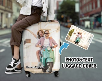 May include: A white luggage cover with a photo of a couple riding a scooter. The text "Dennis & Lucia" is printed on the cover. The text "PHOTO & TEXT LUGGAGE COVER" is printed below the image.