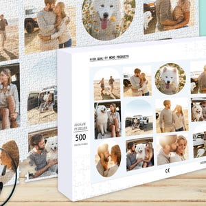 May include: A white box with a jigsaw puzzle on the front. The puzzle is 500 pieces and features a photo of a couple and their dog. The box is white with black text and a photo of the puzzle on the front. The text on the box reads "Jigsaw Puzzles 500 Pieces Puzzle".