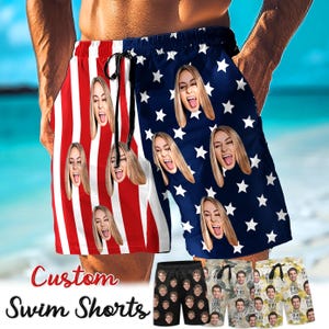 May include: Custom swim shorts with a red and white striped pattern and a blue background with white stars. The shorts feature a repeating pattern of a person's face. The text "Custom Swim Shorts" is displayed.