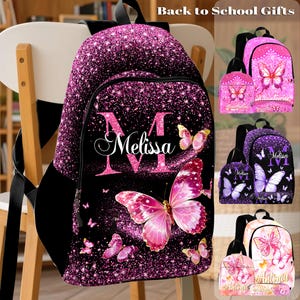 May include: A black backpack with a pink glitter design and butterfly accents. The backpack features the name "Melissa" in white script and the initial "M" in pink. The image also shows other backpacks with butterfly designs.