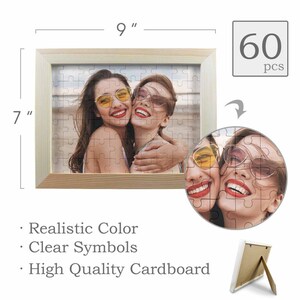 May include: A 60-piece jigsaw puzzle in a wooden frame with a picture of two women smiling and wearing sunglasses. The puzzle is 7 inches by 9 inches.