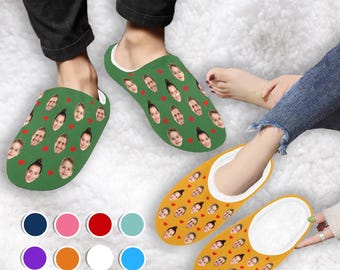 May include: A pair of green and yellow slippers with a pattern of faces and hearts. The slippers are made of soft, comfortable material and have a fleece lining.