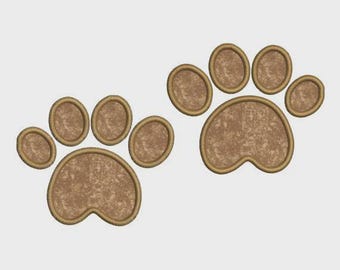 May include: Two brown paw prints with a textured appearance and a gold outline. The paw prints are side by side, each with four toes and a larger pad. The design is simple and suitable for pet-related products.