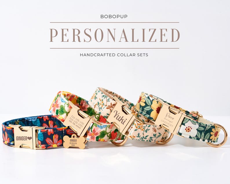 May include: Four personalized handcrafted dog collar sets with floral patterns. Each collar features a gold-colored buckle and a matching tag with a name and contact information. The collars are in shades of blue, yellow, and cream.