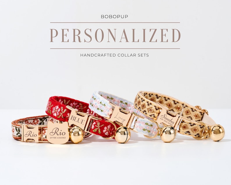 May include: Three personalized cat collars with gold buckles and bells. The collars are red with floral embroidery, white with floral embroidery, and beige with a geometric pattern. The collars are labeled "Rio", "Blue", and "Simba".