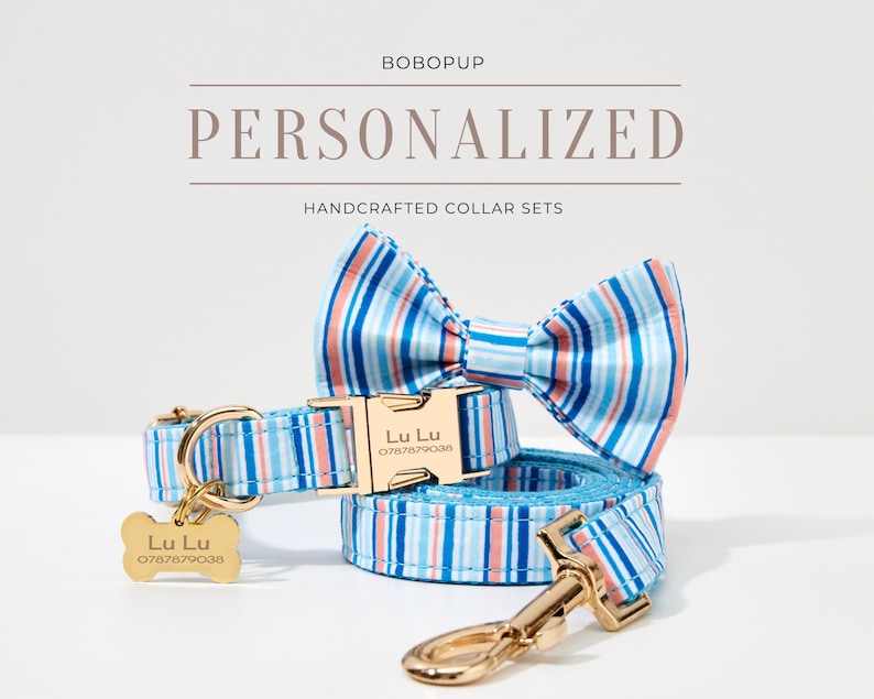 May include: A personalized dog collar set with a matching bow tie and leash. The set features a blue and white striped pattern with gold-colored hardware. The collar and tag are engraved with the name "Lu Lu" and a phone number.