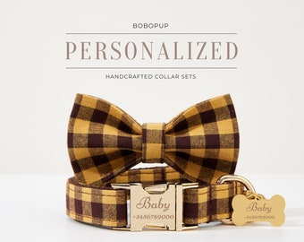 May include: A yellow and brown plaid dog collar and bow tie set with a gold metal buckle and a personalized tag that reads "Baby +3456789000".