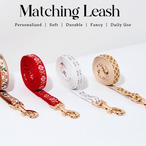 May include: Four dog leashes with gold clasps. The leashes are made of brown, red, white, and beige fabric with embroidered floral patterns. The text "Matching Leash" is at the top of the image. The text "Personalized | Soft | Durable | Fancy | Daily Use" is below the text "Matching Leash".