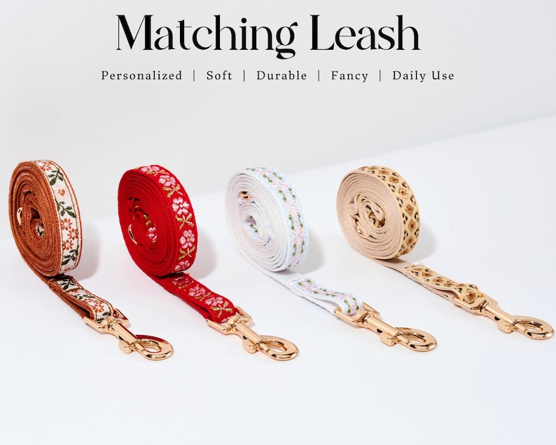 May include: Four dog leashes with gold clasps. The leashes are made of brown, red, white, and beige fabric with embroidered floral patterns. The text "Matching Leash" is at the top of the image. The text "Personalized | Soft | Durable | Fancy | Daily Use" is below the text "Matching Leash".