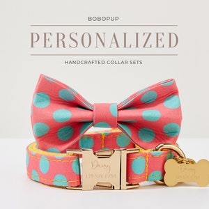May include: A pink and blue polka dot dog collar and bow tie set with a gold buckle and bone tag. The tag is engraved with the name "Daisy" and a phone number. The set is handcrafted and personalized.
