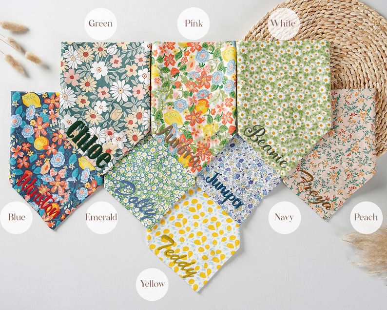 May include: A collection of colorful floral patterned dog bandanas in various colors, including blue, green, pink, and yellow. Each bandana is personalized with a name in a complementary color. The bandanas are arranged on a neutral background.