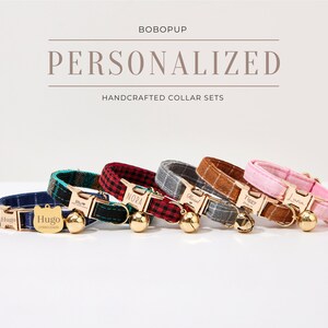 May include: A set of six personalized cat collars with different plaid patterns and gold-toned bells. The collars are handcrafted and feature engraved name tags with the names "Hugo", "Nova", "Hazel", "Troy", "Luna", and "Liam".