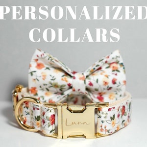 Könnte beinhalten: Ein weißes Hundehalsband mit Blumenmuster und einer goldenen Schnalle. Die Schnalle ist mit dem Namen "Luna" graviert. Das Halsband wird mit einer passenden Blumen-Schleife geliefert.