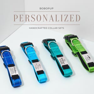 Peut inclure: Quatre colliers de chien personnalisés en bleu, vert et turquoise avec des étiquettes gravées en argent. Les colliers sont faits de sangle en nylon durable et disposent d'une fermeture à boucle sécurisée. Le texte sur les étiquettes de nom est "Phillips", "Wildcat", "Sally" et "The Best Dad Ever". BOBOPUP COLLIERS PERSONNALISÉS ARTISANAUX