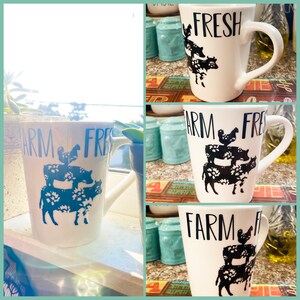 May include: White ceramic mug with black text that reads "FARM FRESH" and a black silhouette of a chicken, pig, and cow.