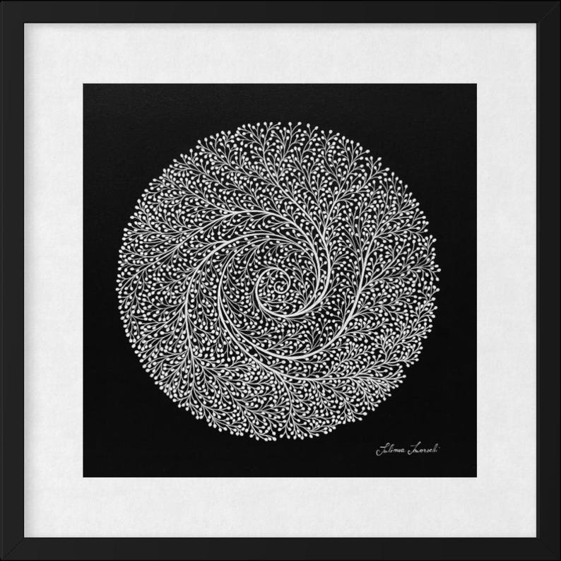 May include: A framed square artwork featuring a white circular design composed of intricate, branching, tree-like patterns on a solid black background. The design spirals toward the center. A signature is visible in the bottom right corner.