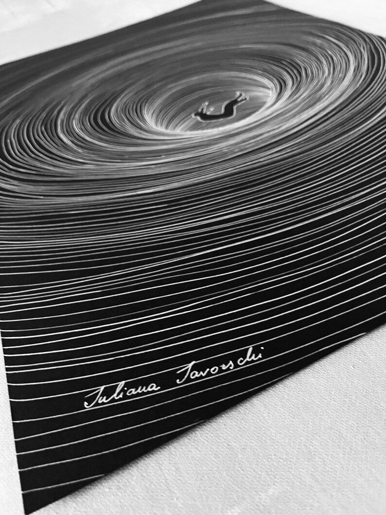 May include: A black and white art print featuring a central figure of a rabbit falling into a deep, swirling vortex of concentric white lines on a solid black background. The artist's signature, Juliana Favorschi, is written in white script at the bottom.