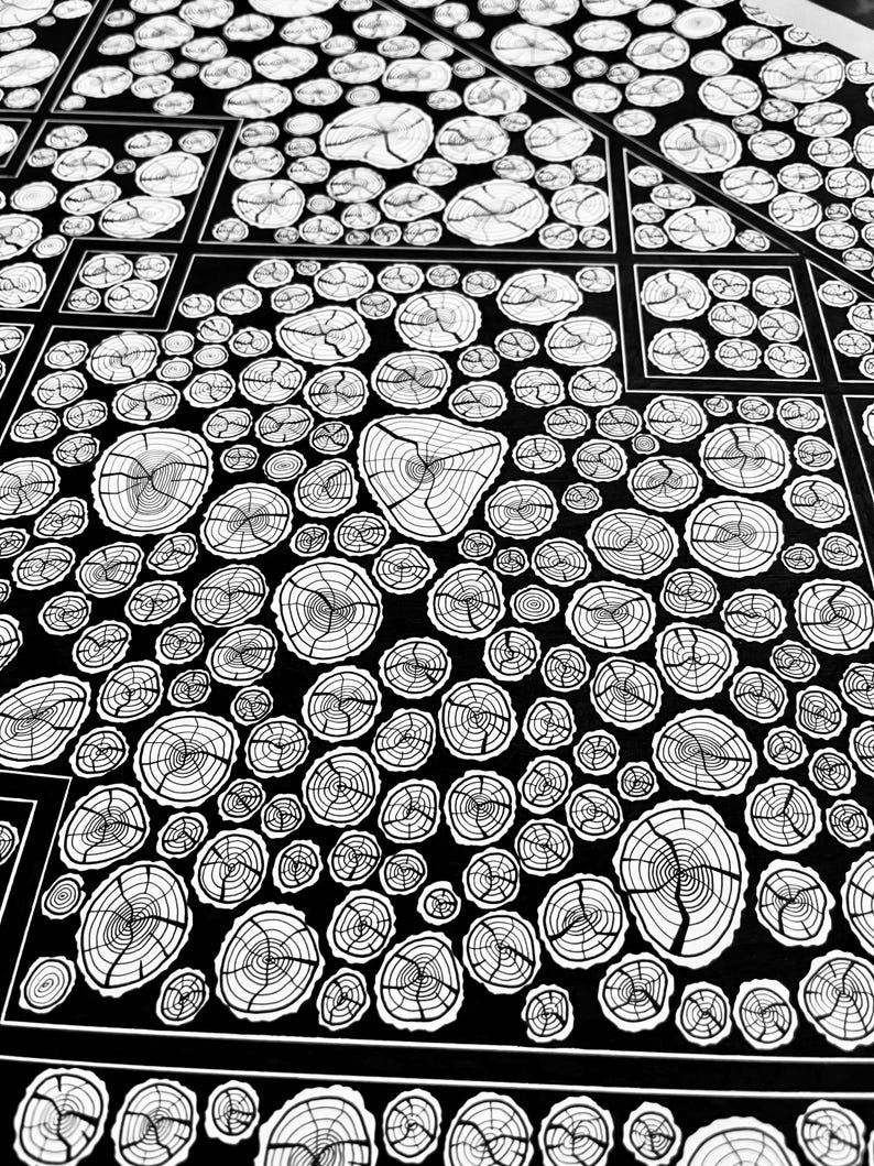 May include: A black and white graphic print featuring a repeating pattern of circular tree ring cross-sections. The design is organized into geometric sections with thin white lines separating the clusters of various sized wood grain circles.