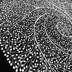 May include: A circular artwork featuring a dense, white ink illustration on a solid black background. The design consists of intricate, branching lines that spiral outward from the center, ending in small, rounded white dots resembling seeds.
